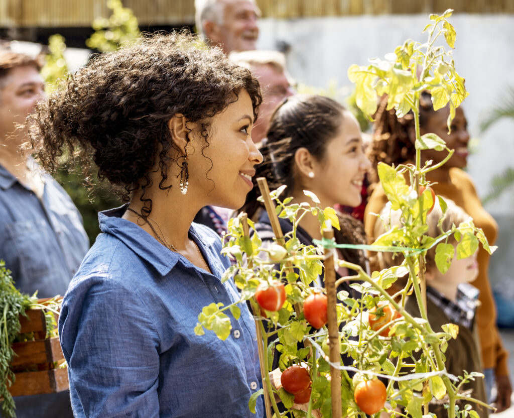 Woman holding tomatoes at gardening event